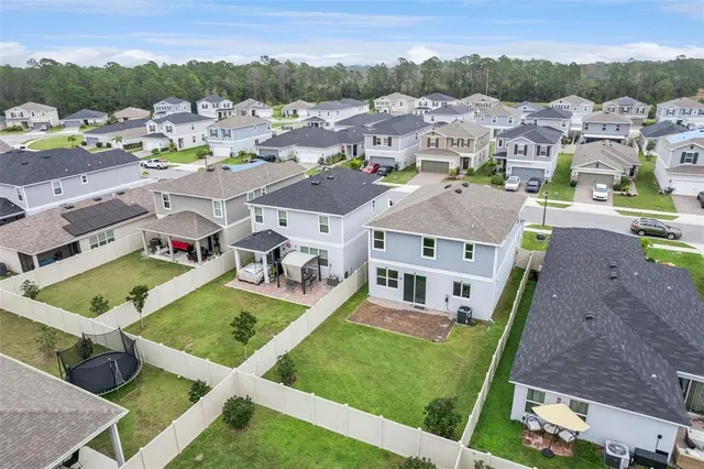 an aerial view of multiple houses with a swimming pool