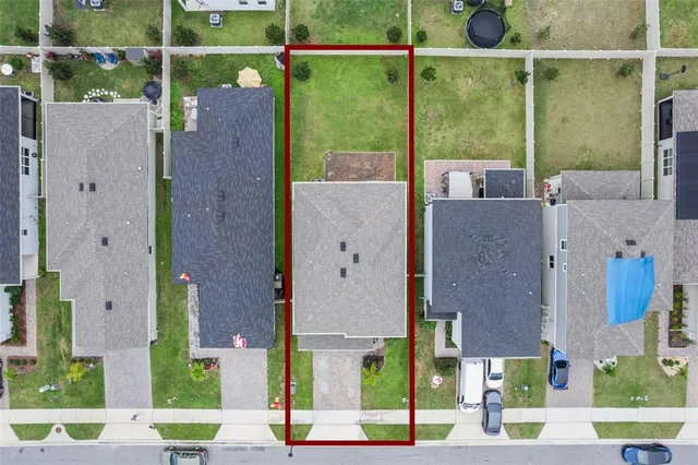 an aerial view of residential houses with outdoor space