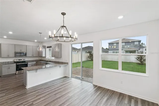 a kitchen with stainless steel appliances granite countertop a stove and cabinets