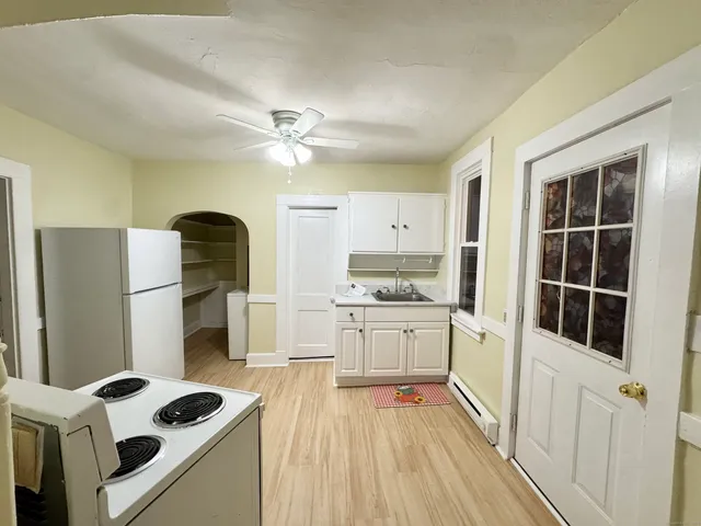 a kitchen with stainless steel appliances a stove a refrigerator and cabinets