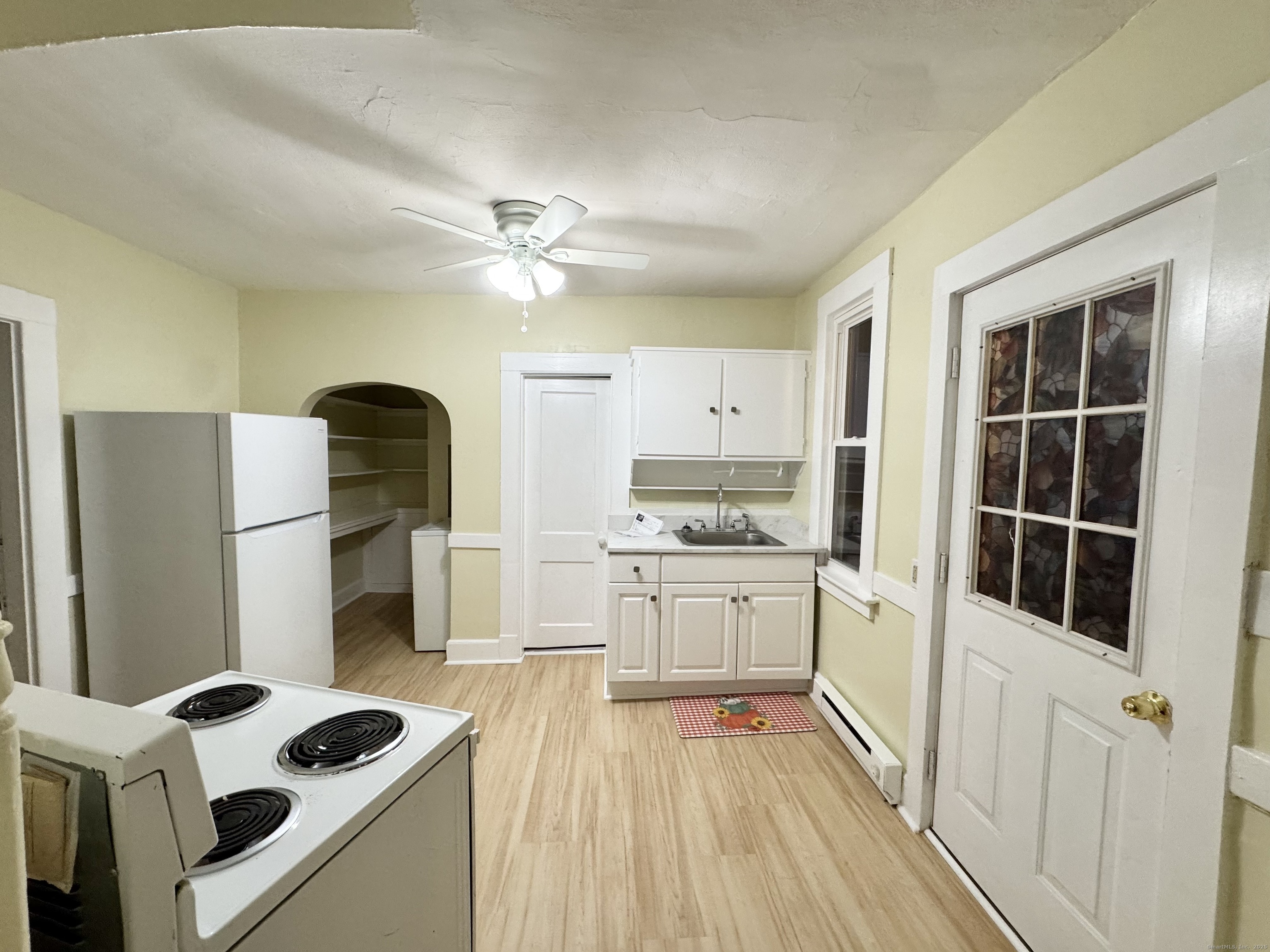 54 New Haven Avenue Waterbury, CT 06708 - Photo 8 of 9 a kitchen with stainless steel appliances a stove a refrigerator and cabinets