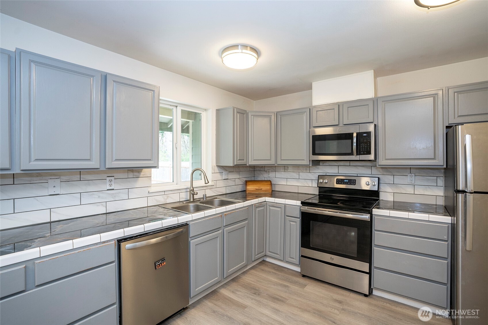 20108 Highway 706 Elbe, WA 98330 - Photo 9 of 37 a kitchen with a sink white cabinets and stainless steel appliances