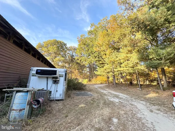 a view of a patio with table and chairs under an umbrella