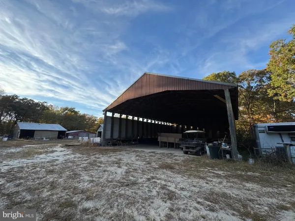 a view of a house with a yard and a car parked