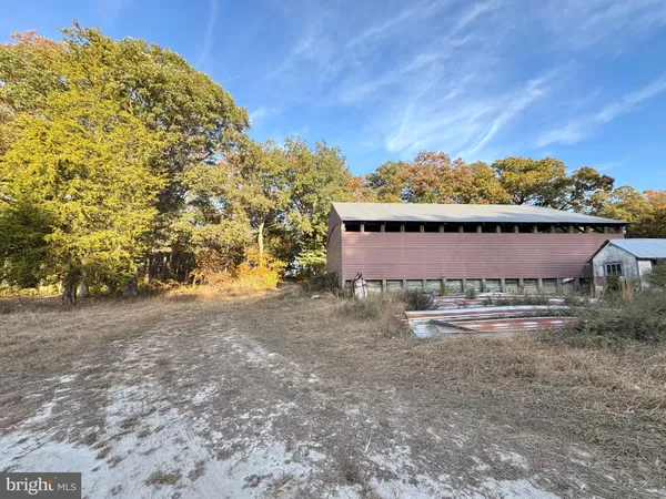 a view of a yard with an house and wooden fence