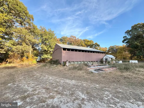 a big yard with table and chairs under an umbrella