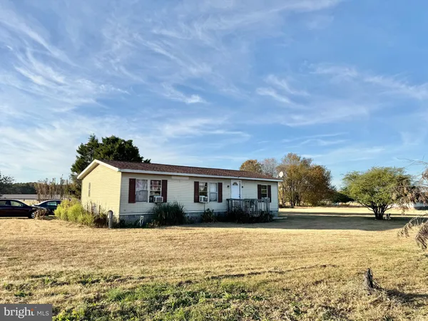 a view of house with yard and ocean view