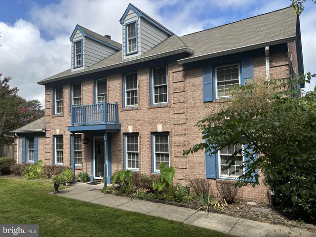 a front view of a house with a yard and porch