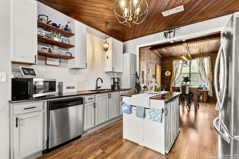 a front view of house with a yard and potted plants