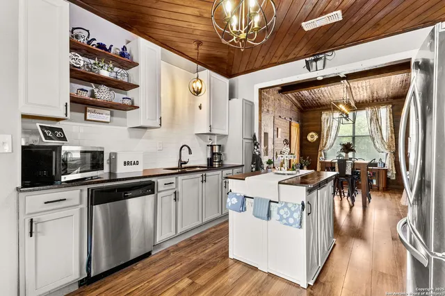 a front view of house with a yard and potted plants