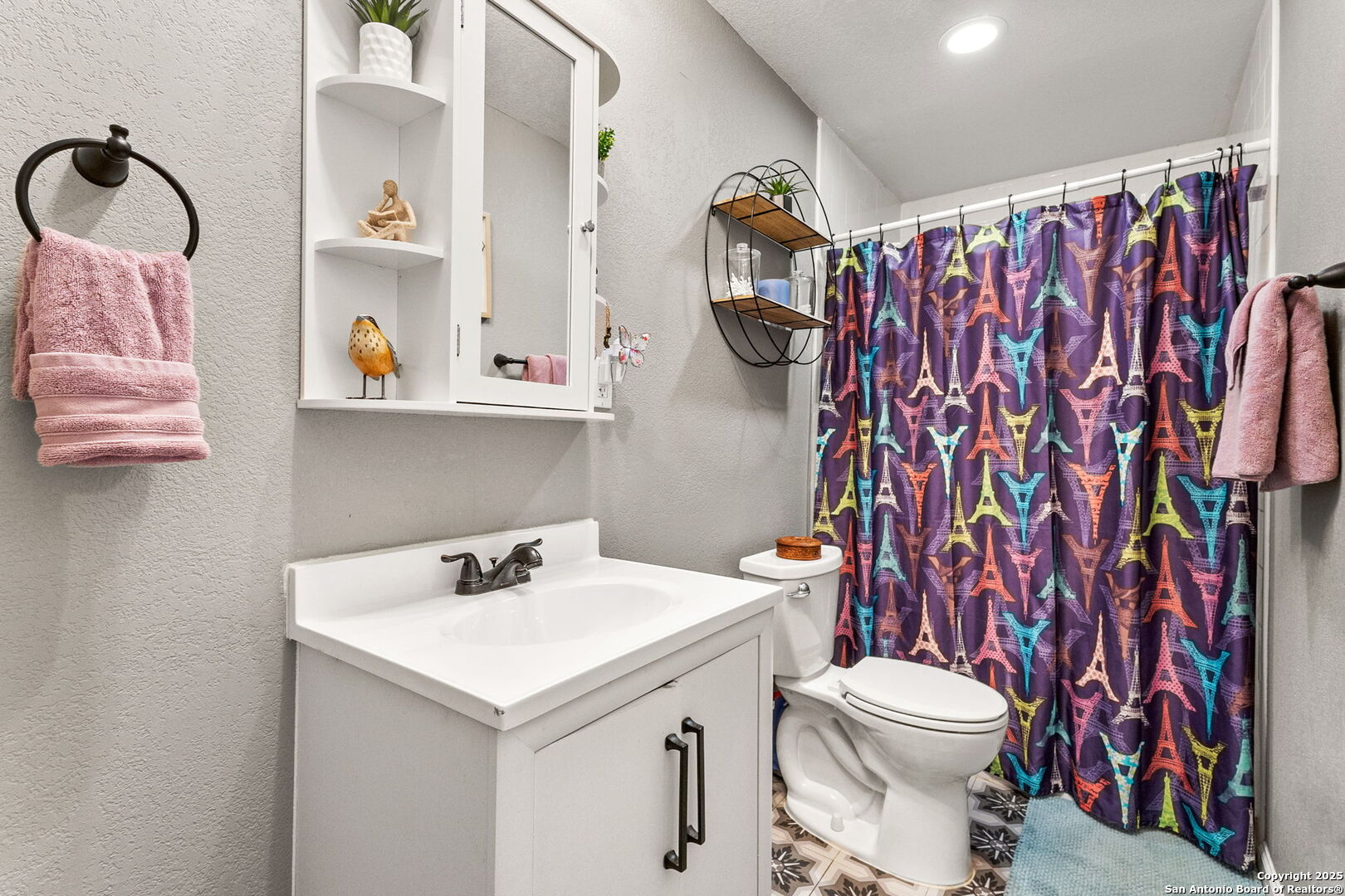 114 Avenue B Converse, TX 78109 - Photo 23 of 26 a bathroom with a sink a toilet and shower curtain