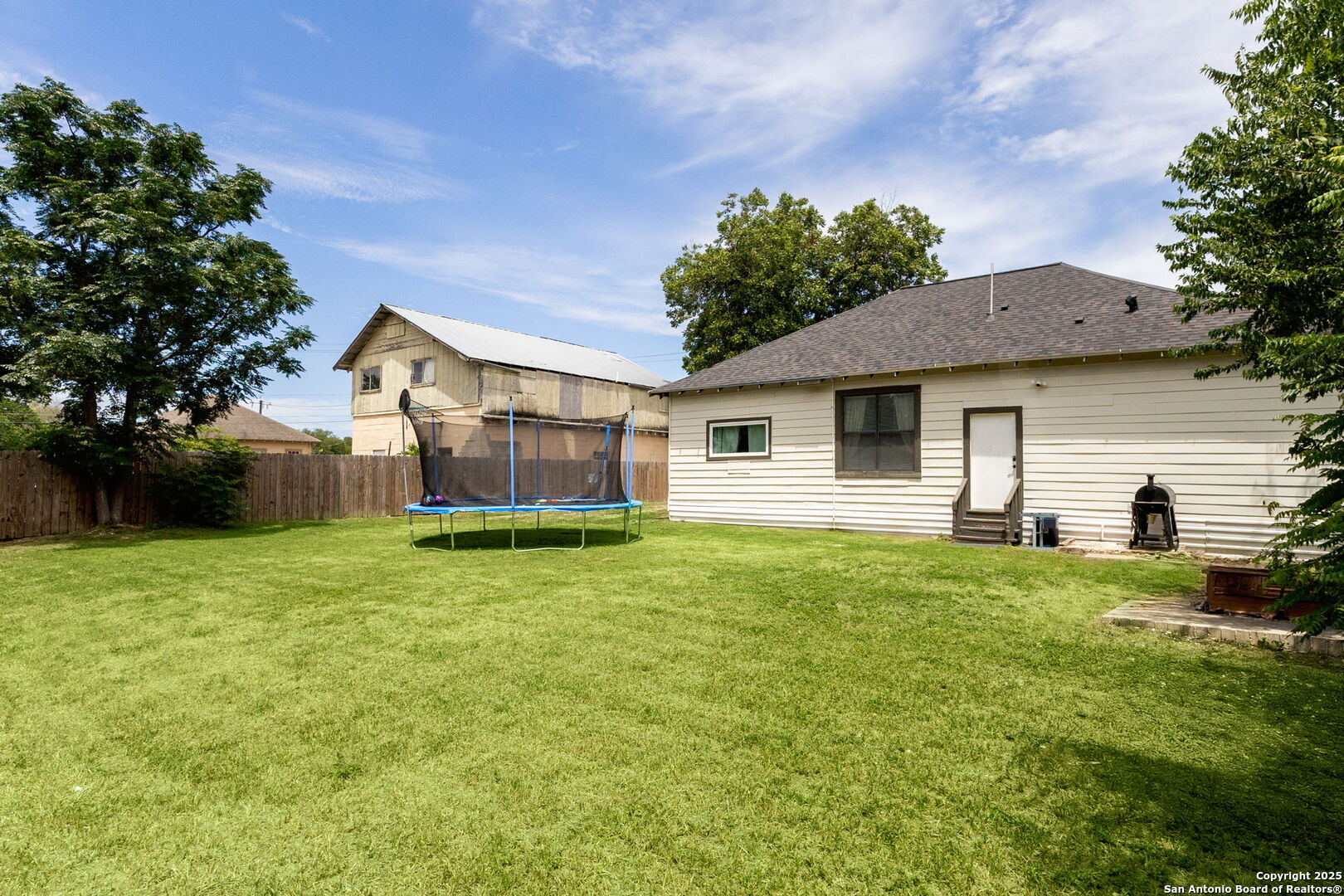 114 Avenue B Converse, TX 78109 - Photo 25 of 26 a backyard of a house with potted plants and large tree