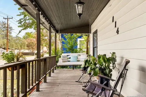 a living room with furniture and painting on the wall