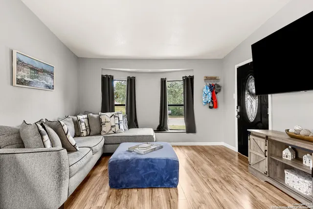 a living room with furniture and a large window