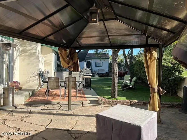 a patio with a table and chairs