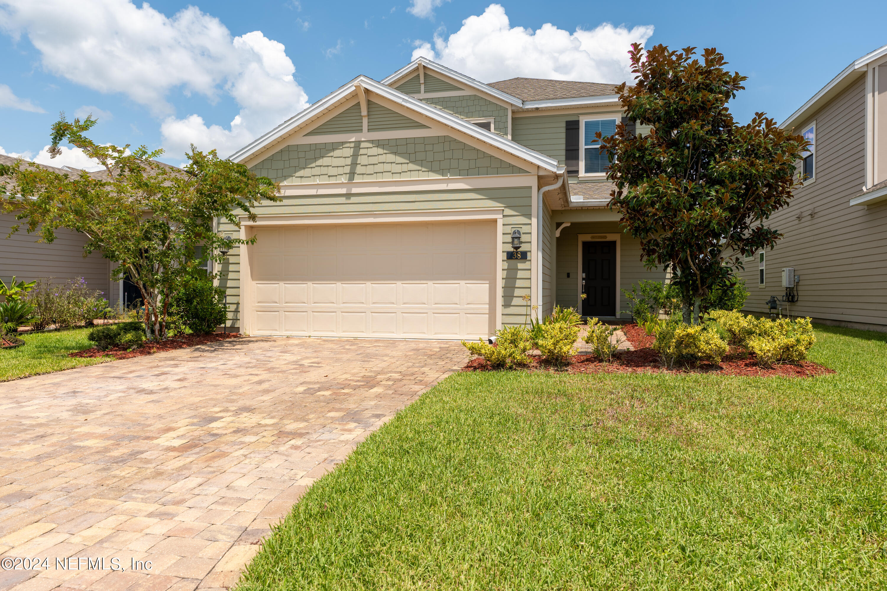 a front view of house with yard and trees around
