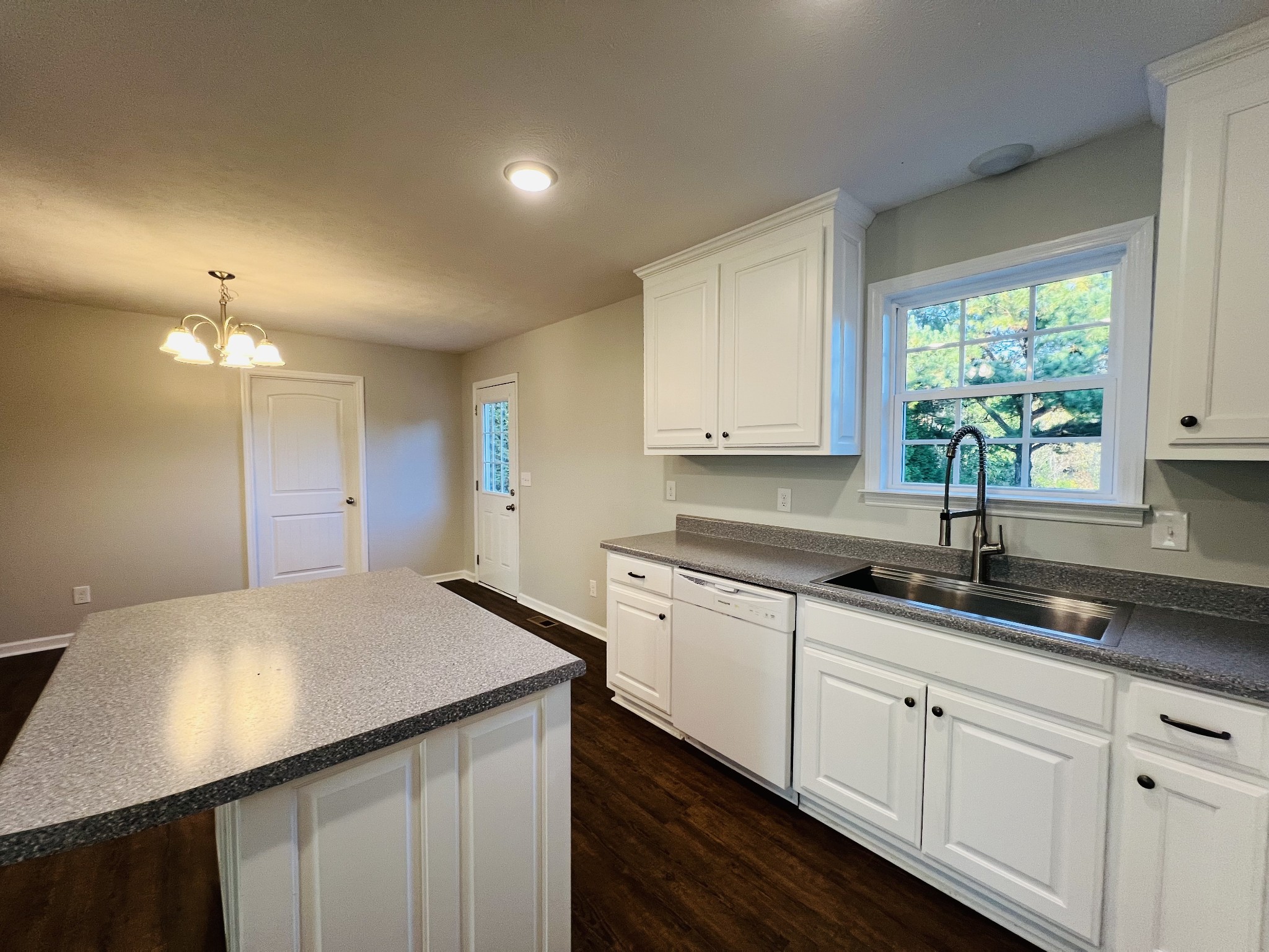 60 Myrick Road Flintville, TN 37335 - Photo 12 of 32 a kitchen with granite countertop white cabinets and window
