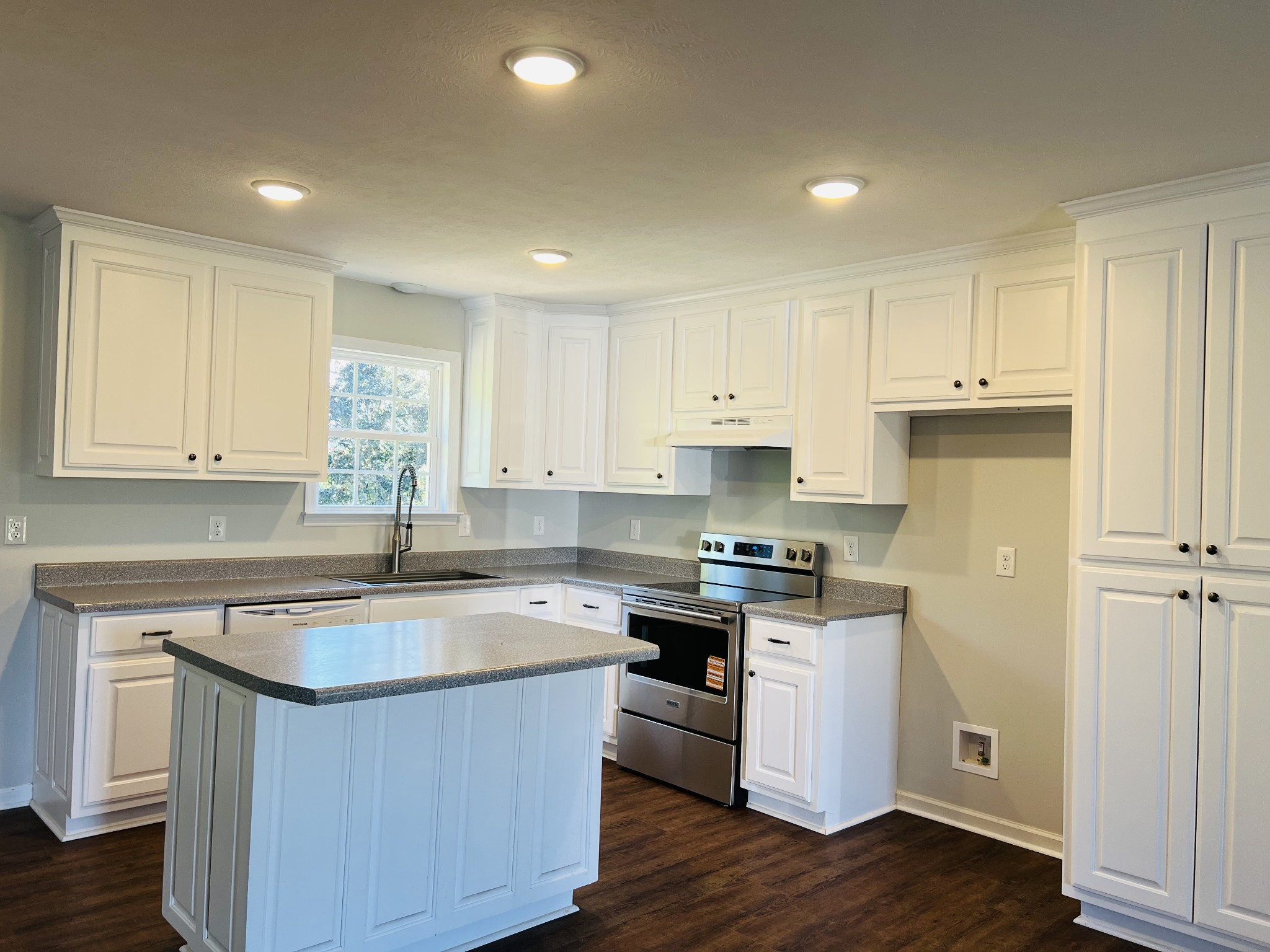 60 Myrick Road Flintville, TN 37335 - Photo 15 of 32 a kitchen with a sink stove a refrigerator and white cabinets