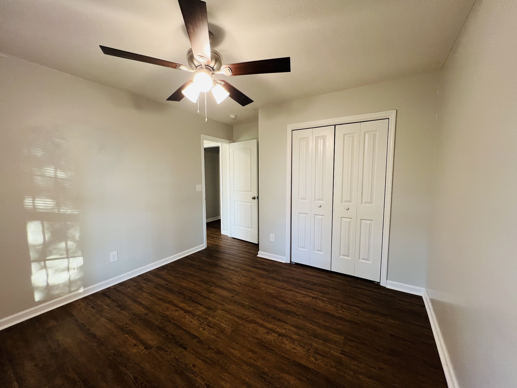 60 Myrick Road Flintville, TN 37335 - Photo 24 of 32 a view of an empty room with wooden floor and a ceiling fan