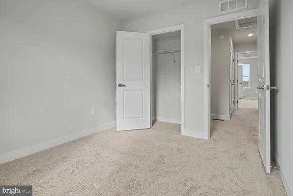an empty room with closet area