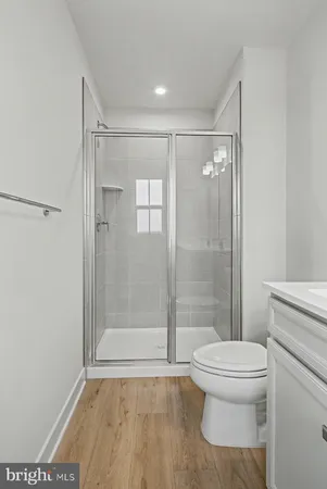 a bathroom with a shower a toilet and a sink