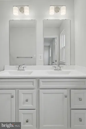 a bathroom with a sink vanity and mirror