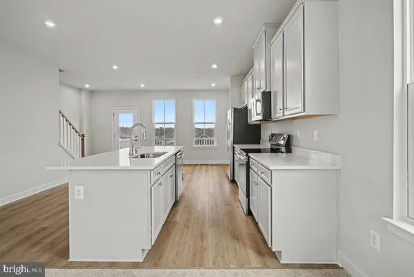 a kitchen with stainless steel appliances granite countertop a sink and cabinets