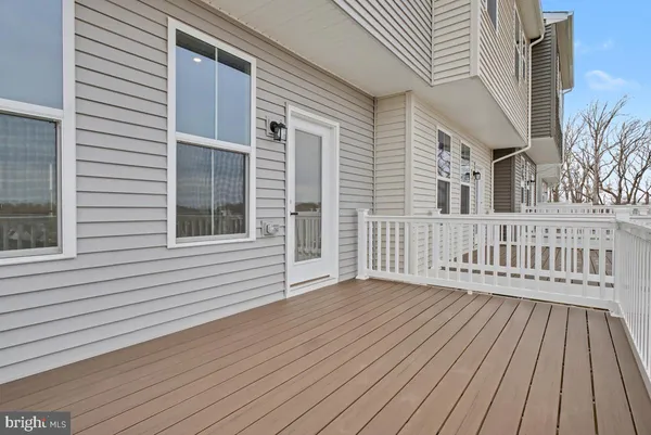 a view of a house with wooden deck