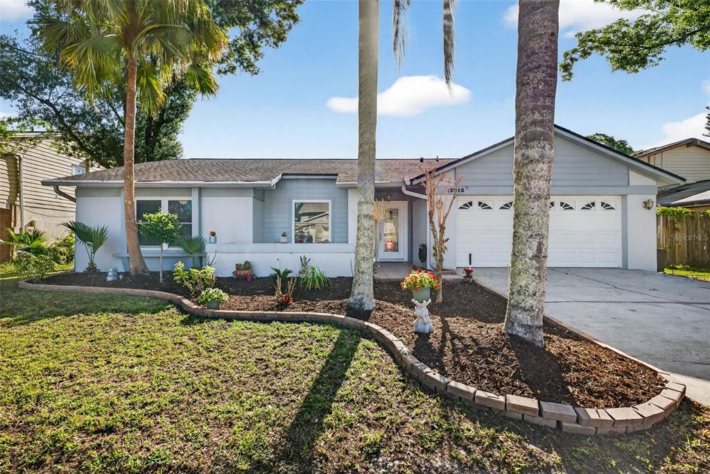 12913 Rain Forest Street Temple Terrace, FL 33617 - Photo 1 of 63 a front view of a house with garden