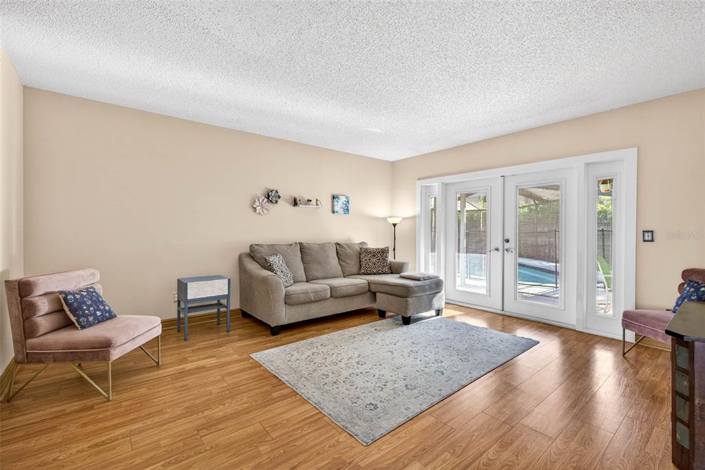 12913 Rain Forest Street Temple Terrace, FL 33617 - Photo 11 of 63 a living room with furniture and a wooden floor