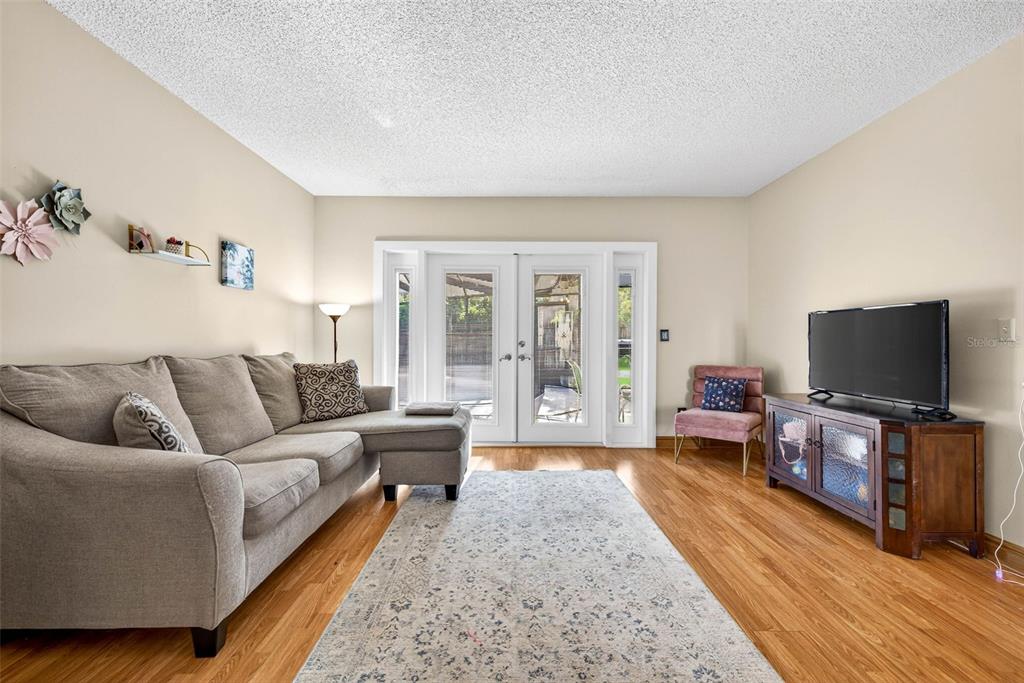 12913 Rain Forest Street Temple Terrace, FL 33617 - Photo 12 of 63 a living room with furniture and a flat screen tv