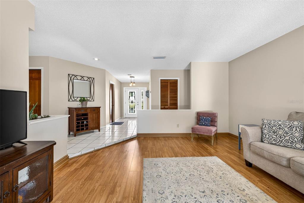 12913 Rain Forest Street Temple Terrace, FL 33617 - Photo 15 of 63 a living room with furniture and a flat screen tv