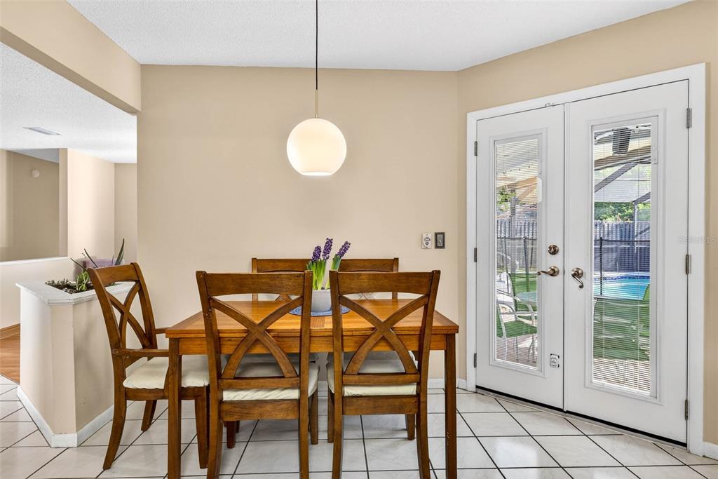 12913 Rain Forest Street Temple Terrace, FL 33617 - Photo 18 of 63 a view of a dining room with furniture and chandelier