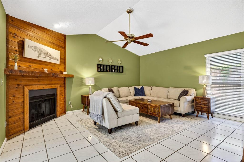 12913 Rain Forest Street Temple Terrace, FL 33617 - Photo 20 of 63 a living room with furniture and a fireplace