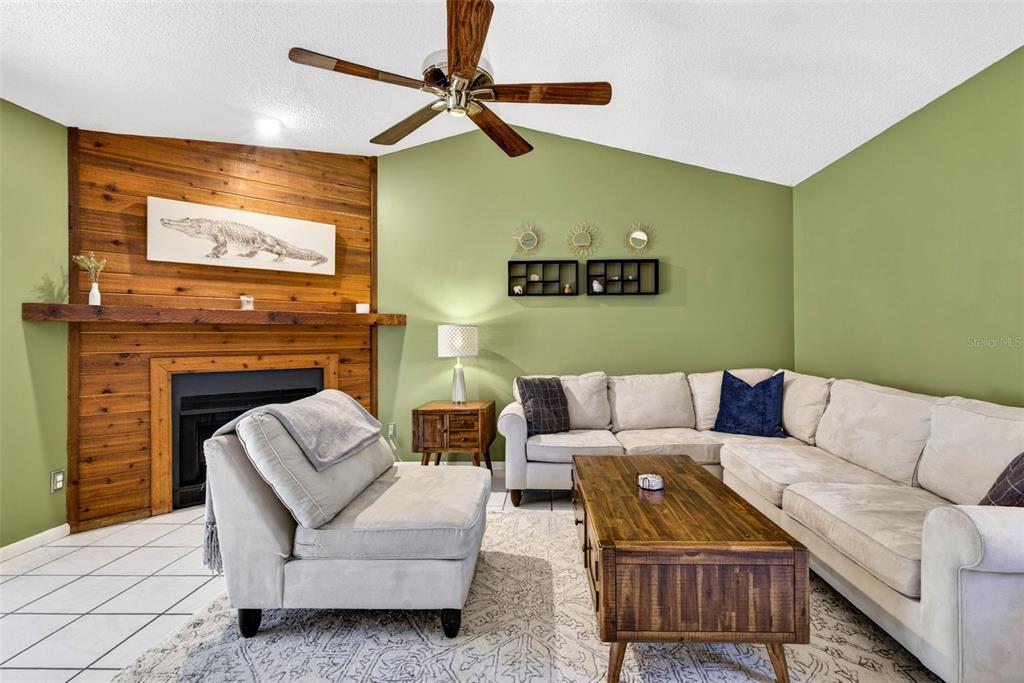 12913 Rain Forest Street Temple Terrace, FL 33617 - Photo 21 of 63 a living room with furniture and a fireplace