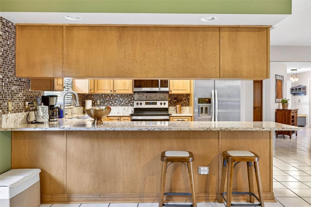 12913 Rain Forest Street Temple Terrace, FL 33617 - Photo 26 of 63 a kitchen with stainless steel appliances a sink and a counter