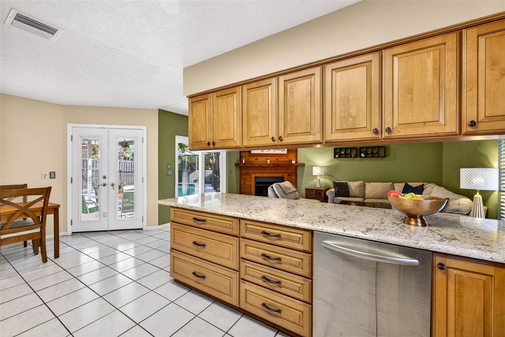 12913 Rain Forest Street Temple Terrace, FL 33617 - Photo 30 of 63 a kitchen with granite countertop a sink cabinets stainless steel appliances and a window