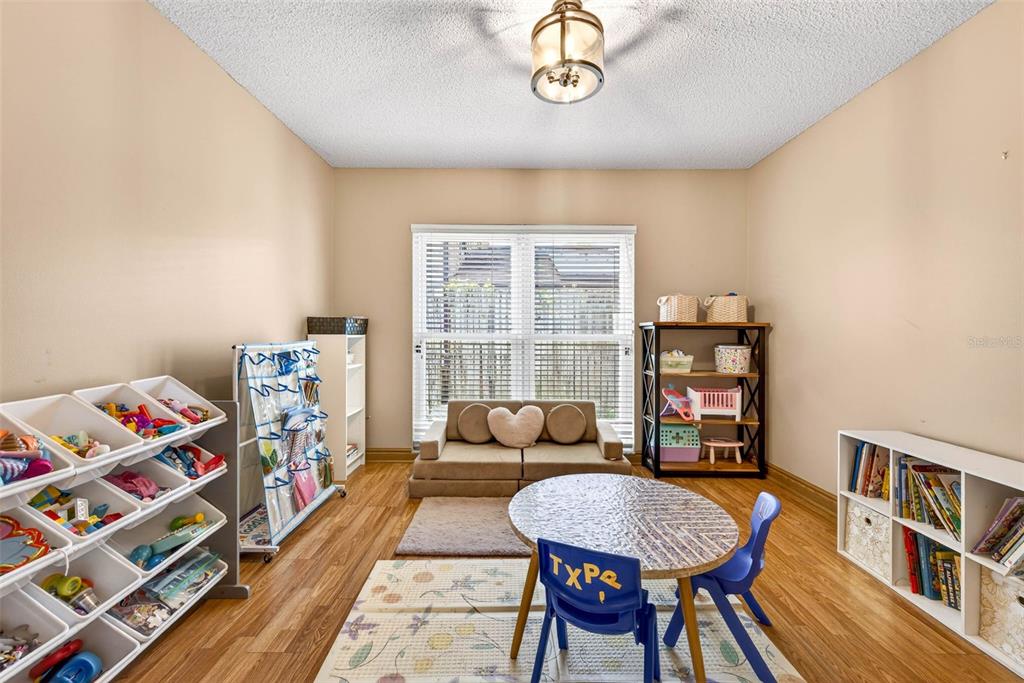 12913 Rain Forest Street Temple Terrace, FL 33617 - Photo 33 of 63 a bedroom with furniture and a wooden floor