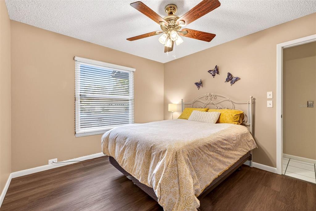 12913 Rain Forest Street Temple Terrace, FL 33617 - Photo 36 of 63 a bedroom with a bed and a chandelier