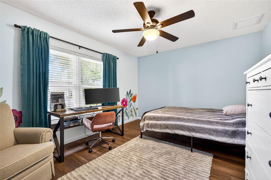 12913 Rain Forest Street Temple Terrace, FL 33617 - Photo 38 of 63 a bedroom with a bed a desk and chair