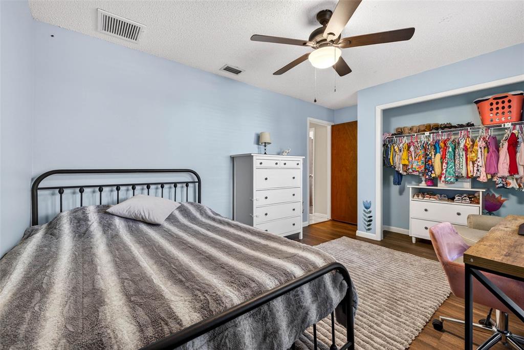 12913 Rain Forest Street Temple Terrace, FL 33617 - Photo 40 of 63 a bedroom with a bed and dresser