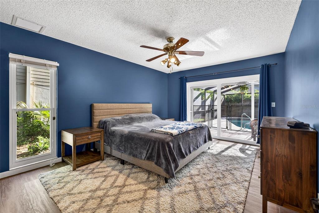 12913 Rain Forest Street Temple Terrace, FL 33617 - Photo 44 of 63 a bedroom with a bed and large window with outer view