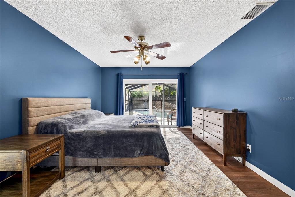 12913 Rain Forest Street Temple Terrace, FL 33617 - Photo 45 of 63 a bedroom with a bed and a chandelier