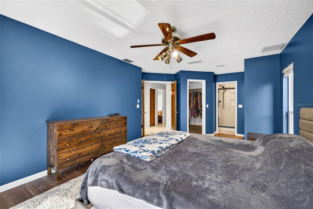 12913 Rain Forest Street Temple Terrace, FL 33617 - Photo 46 of 63 a bedroom with a bed and a chandelier