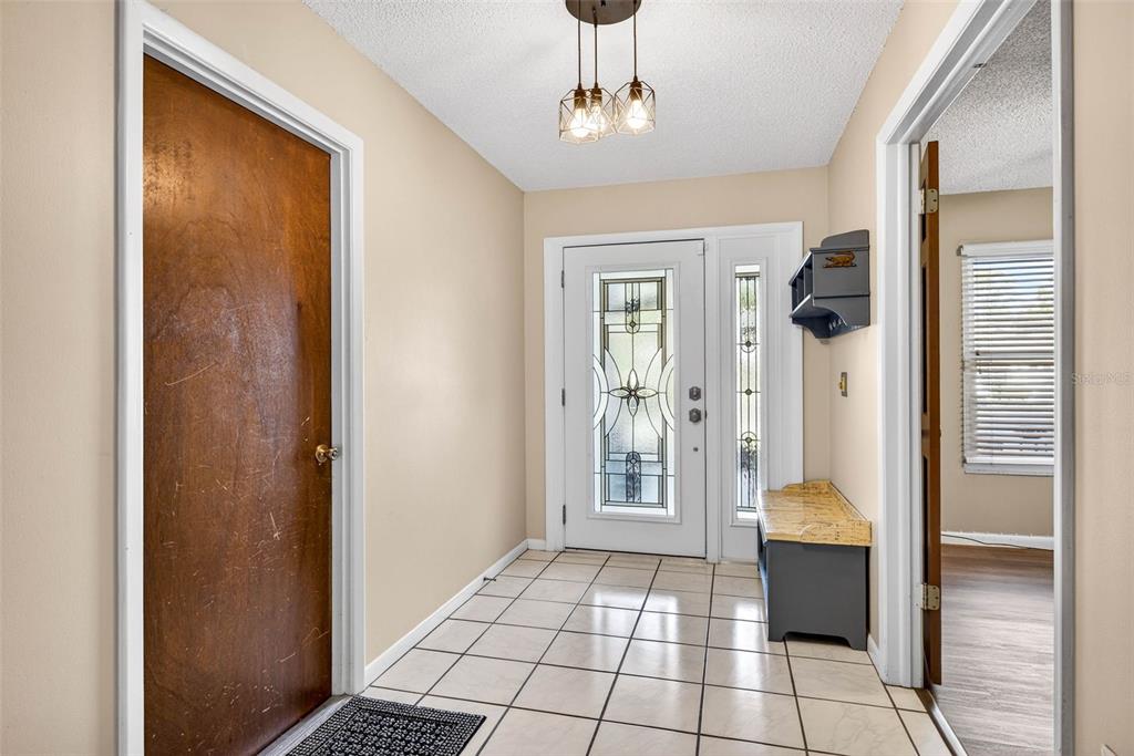 12913 Rain Forest Street Temple Terrace, FL 33617 - Photo 9 of 63 a view of a hallway view with wooden floor and staircase
