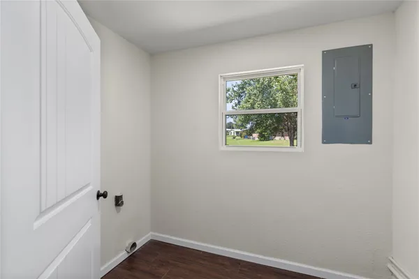 a view of a small space with wooden floor and a window
