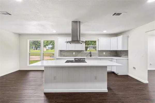a kitchen with stainless steel appliances a sink window and cabinets