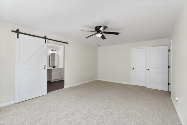 a view of empty room with ceiling fan
