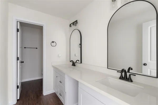 a bathroom with a double vanity sink and a mirror