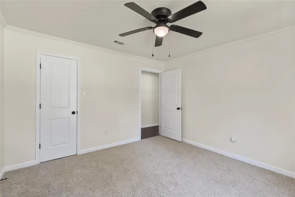 an empty room with a ceiling fan